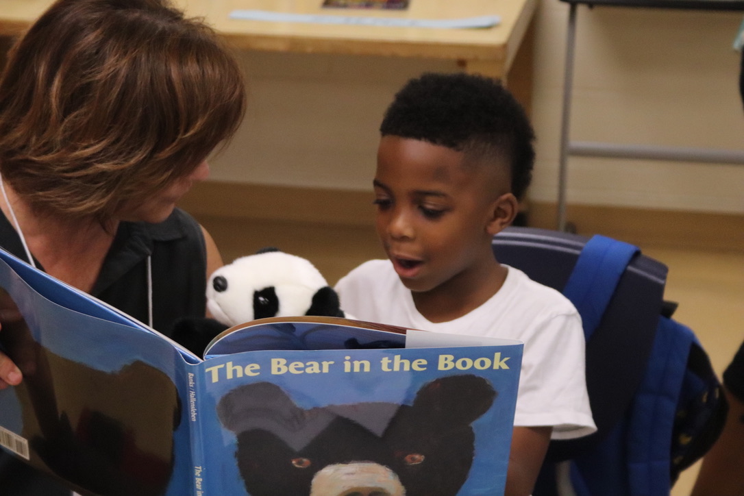 Student and teacher reading together